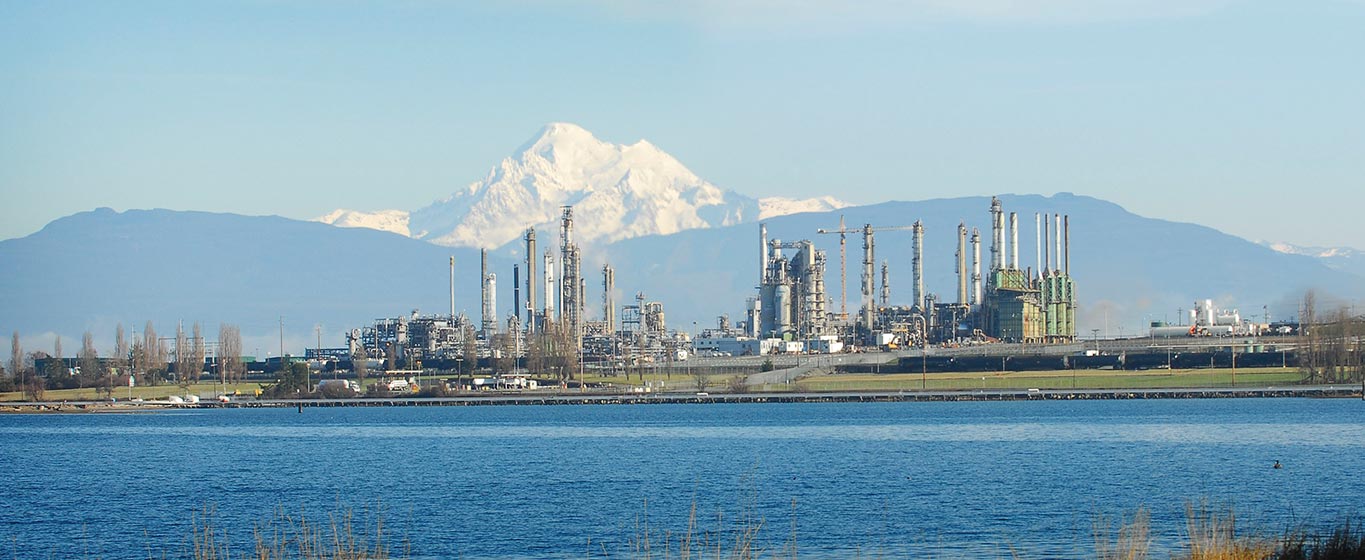 Anacaortes Refinery in Washington State from across the water with a mountain in the background