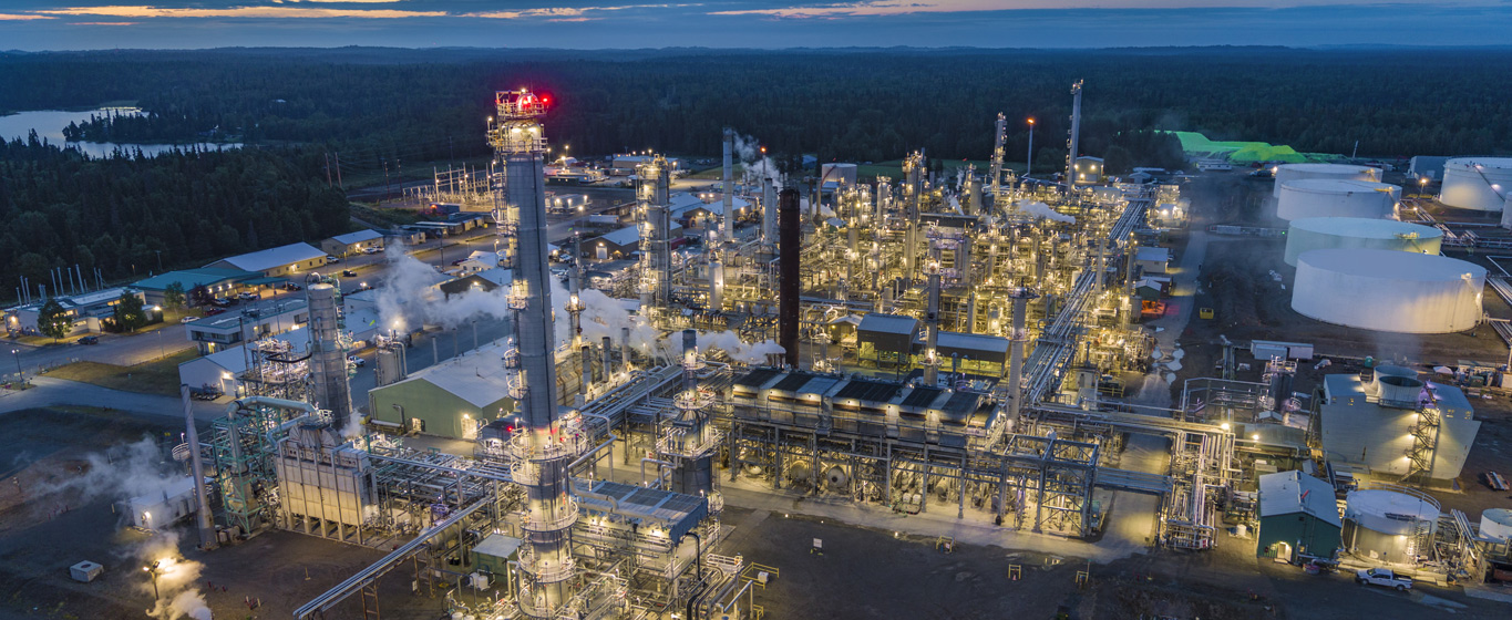 Overhead view of the Kenai Refinery with an Alaskan Mountain range off in the distance